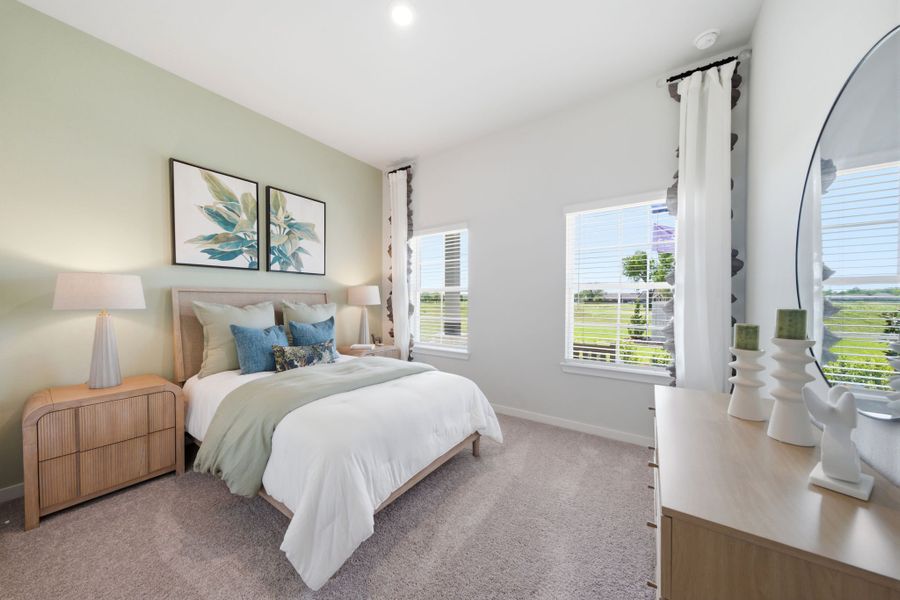 A bedroom with a bed and a window.
