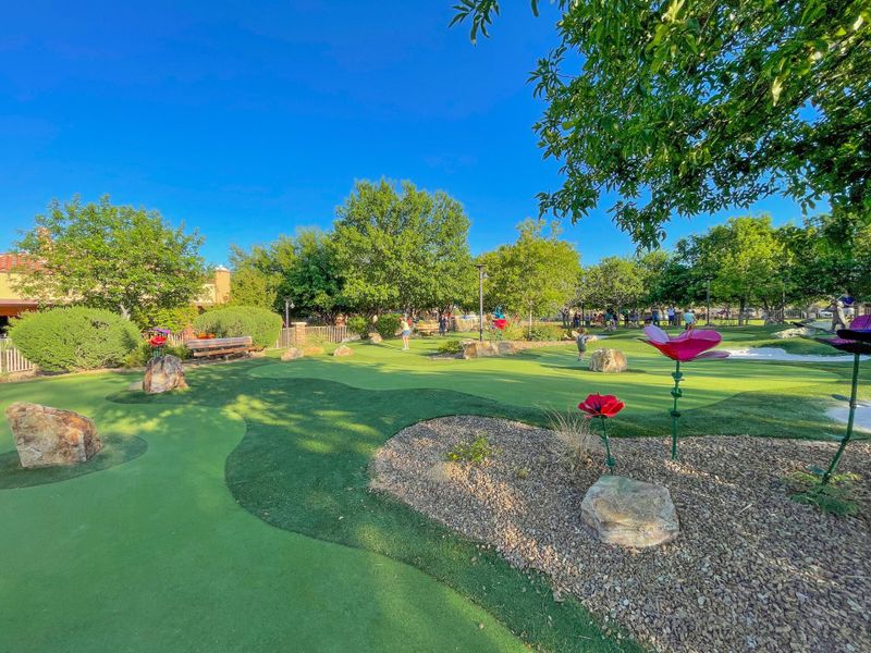 A golf course with a green field.