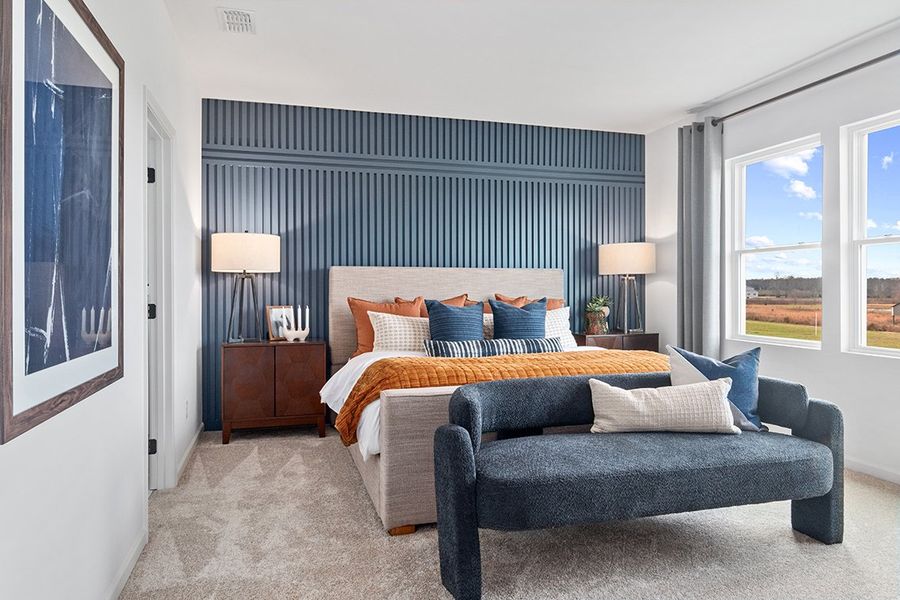 A bedroom with a bed and a couch. A bedroom with a bed and a couch.