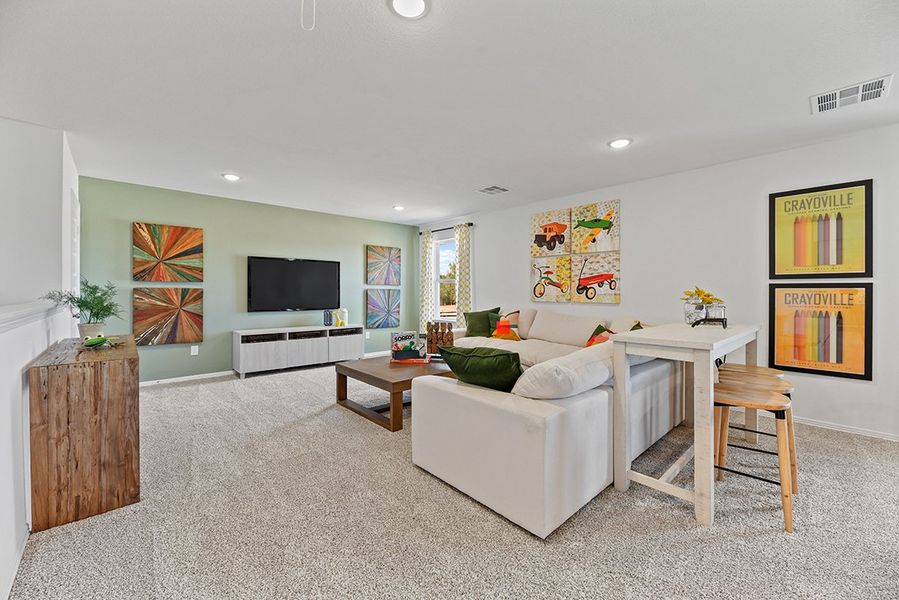 A living room with a white couch and a tv. A living room with a white couch and a tv.