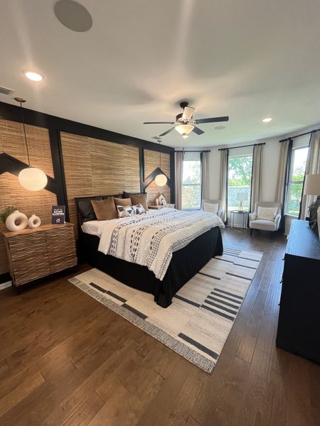 A cozy bedroom featuring wood accents, textured walls, and elegant lighting, creating a warm, inviting atmosphere.