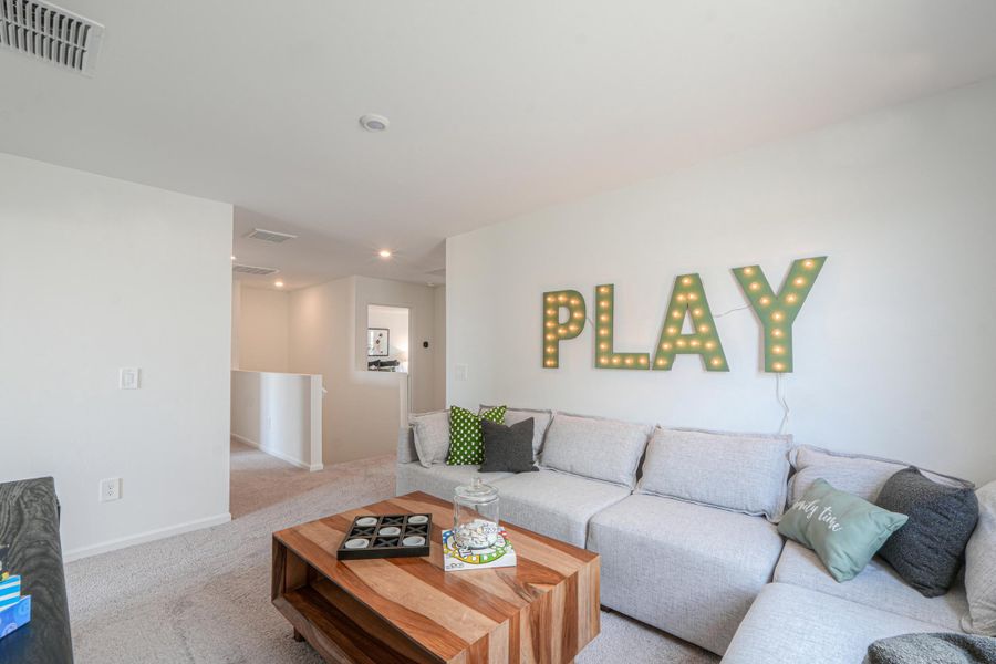 A living room with a couch and a coffee table. A living room with a couch and a coffee table.