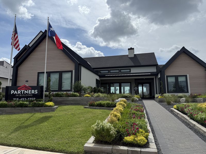 A modern home with a sleek design and vibrant landscaping in Sienna by Partners in Building (Missouri City, TX).