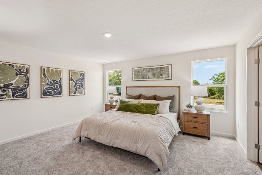 A bedroom with a bed and a window. A bedroom with a bed and a window.
