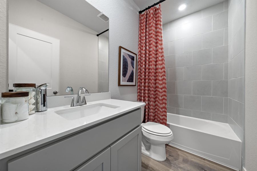 A bathroom with a sink toilet and bathtub.