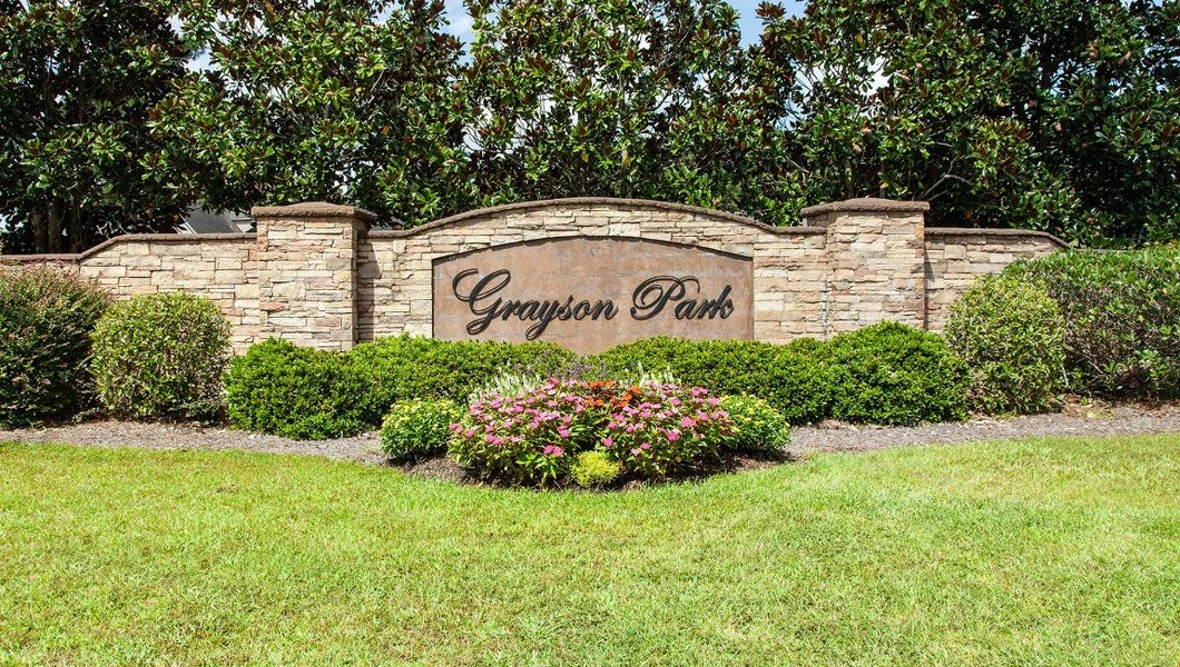 Entrance to the Grayson Park Townhomes community in Leland, NC, featuring signage and landscaping (Image 2).