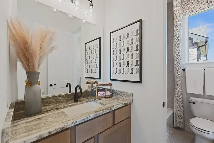 Furnished interior in a model home at Brookewater 60's in Rosenberg (Image 29).
