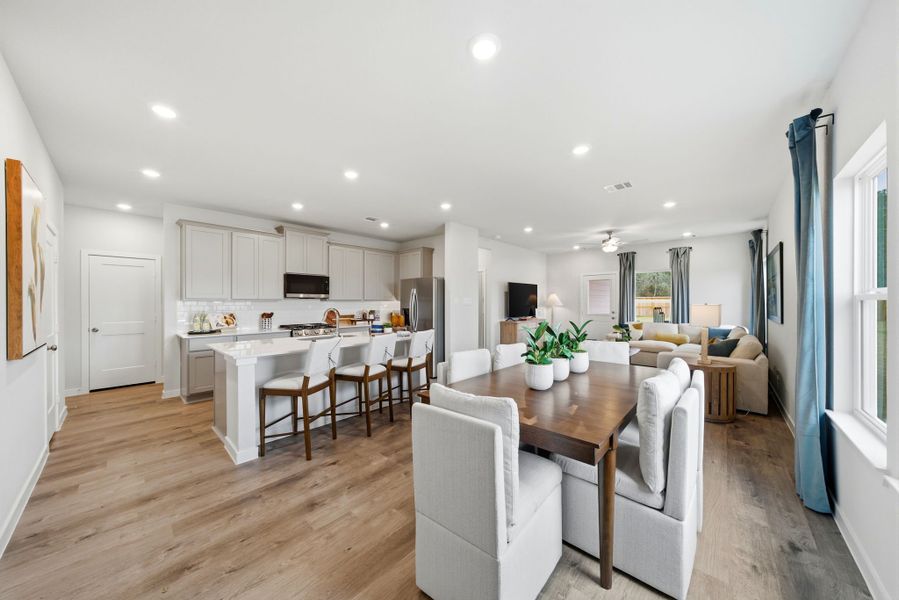 A large kitchen with a dining table.