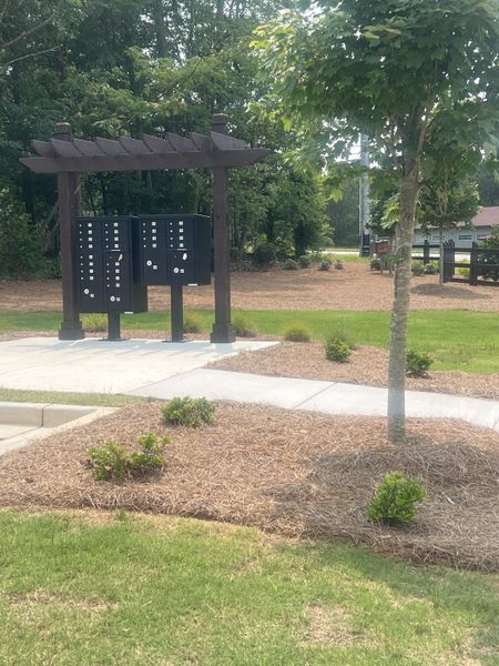 Community mailboxes with a charming wooden pergola and landscaping in The Overlook at Factory Shoals by Kerley Family Homes (Mableton, GA). Community mailboxes with a charming wooden pergola and landscaping in The Overlook at Factory Shoals by Kerley Family Homes (Mableton, GA).