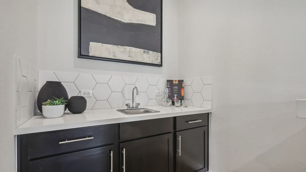 Elegant hexagonal backsplash and sleek black cabinetry define this Churchill wet bar. Elegant hexagonal backsplash and sleek black cabinetry define this Churchill wet bar.
