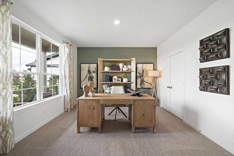 A room with a desk and a window. A room with a desk and a window.