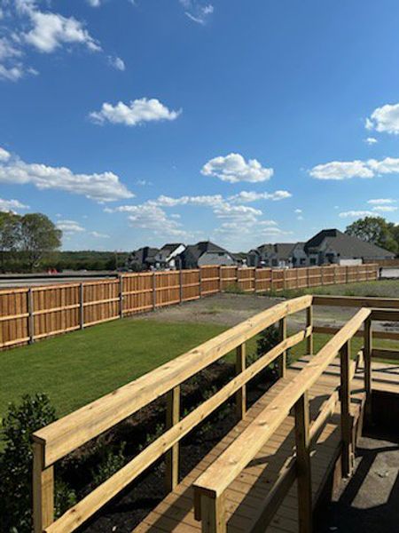 New homes with wooden fences and landscaped lawns in Hillstead 60' by Perry Homes (Lavon, TX).