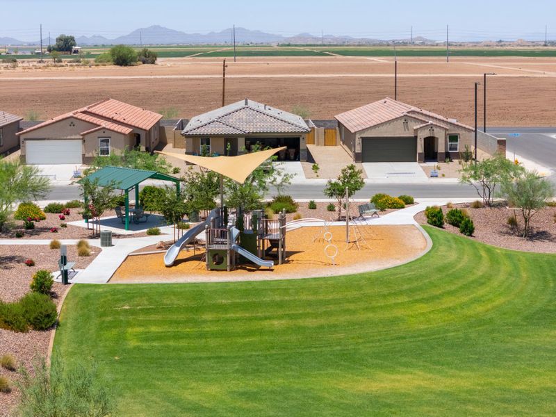A golf course with a few buildings.