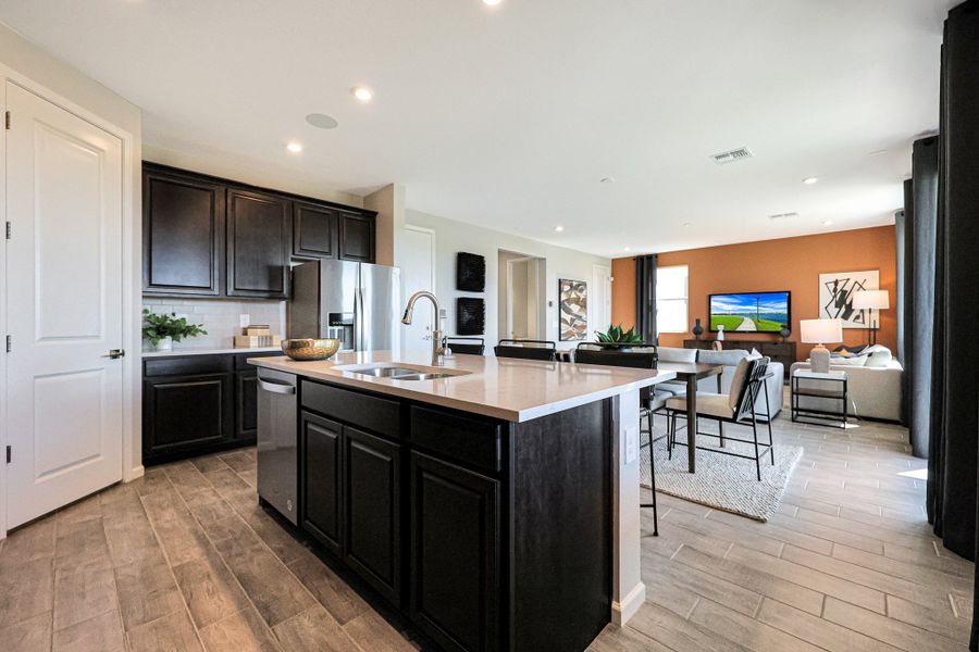 A kitchen with black cabinets. A kitchen with black cabinets.