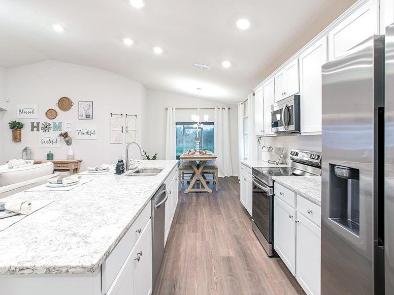 Your new kitchen is complete with a large island, Samsung appliances, and beautiful finishes - Parker model home in Eagle Lake, FL