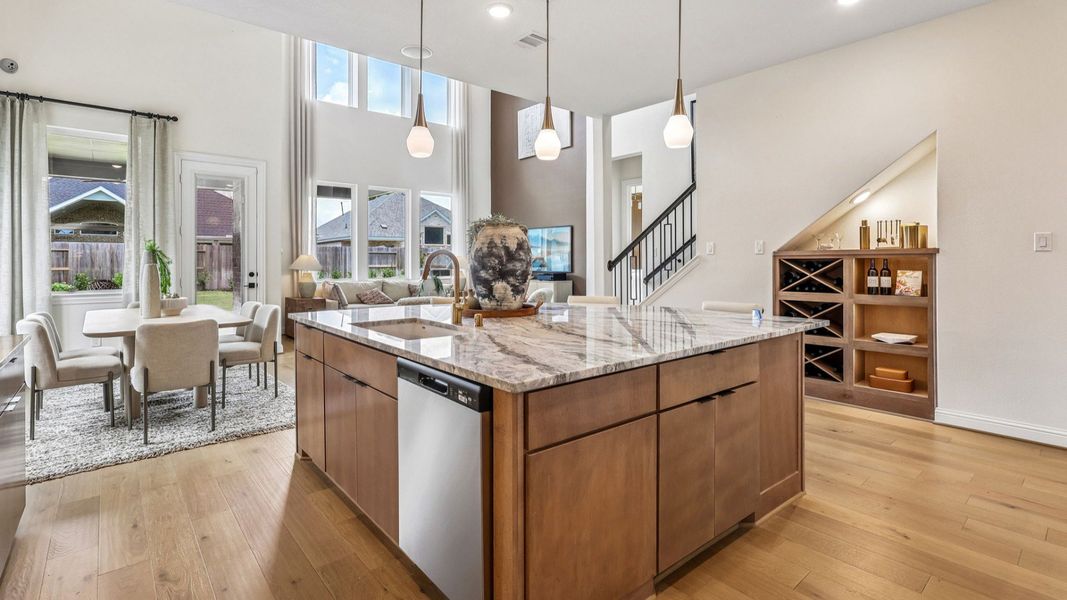 Elegant marble countertops and pendant lights highlight this exquisite kitchen in Brookewater community.