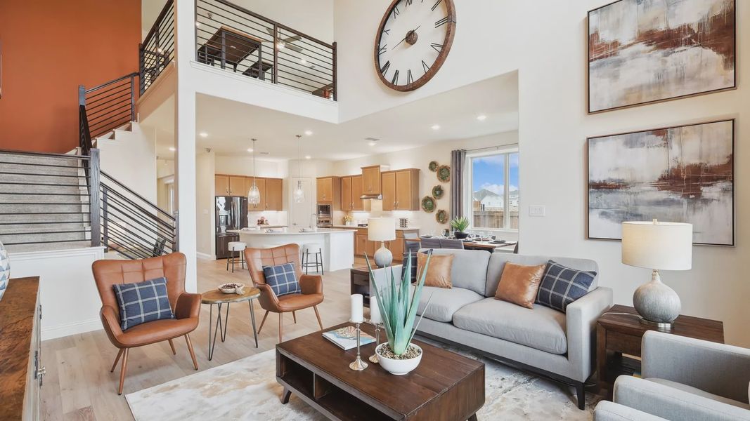 Elegant open-concept living with a striking wall clock and designer finishes in The Oaks.