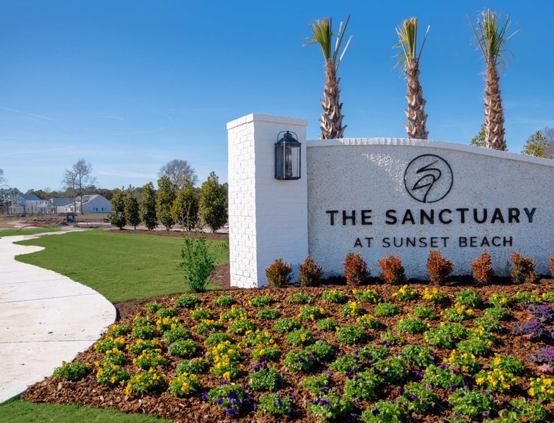 Entrance to the The Sanctuary at Sunset Beach community in Sunset Beach, NC, featuring signage and landscaping (Image 9).