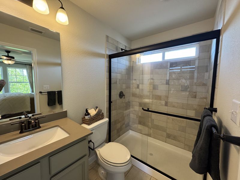 A modern bathroom featuring a sleek glass shower, elegant vanity, and warm lighting for a cozy atmosphere. A modern bathroom featuring a sleek glass shower, elegant vanity, and warm lighting for a cozy atmosphere.
