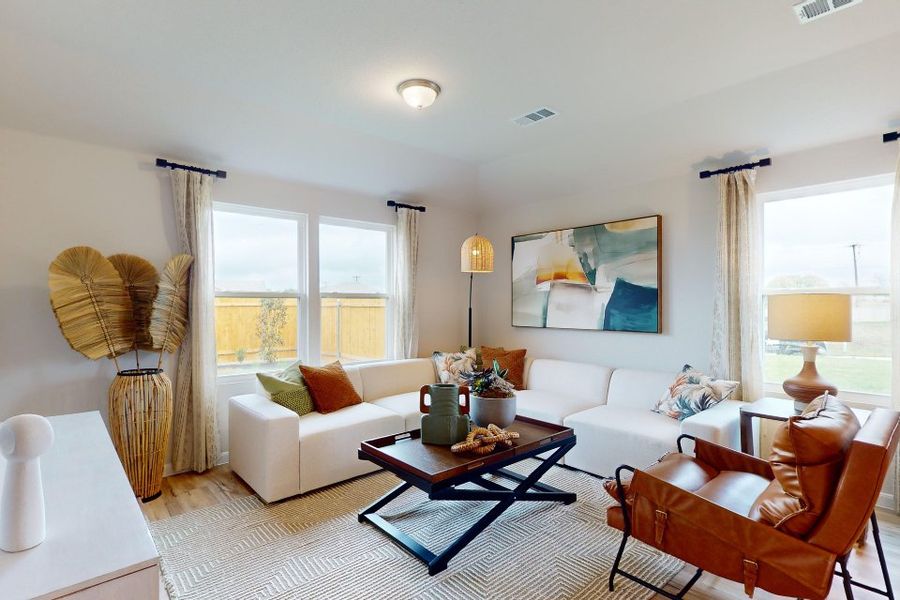 A living room with a white couch and a coffee table. A living room with a white couch and a coffee table.