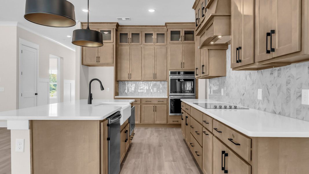 Gorgeous kitchen finishes with tile backsplash, upgraded cabinets, and quartz countertops Gorgeous kitchen finishes with tile backsplash, upgraded cabinets, and quartz countertops