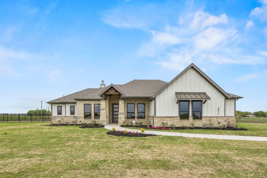 Front exterior of a home in the Carrera Ranch community, located in Waxahachie, TX (Image 1). Front exterior of a home in the Carrera Ranch community, located in Waxahachie, TX (Image 1).