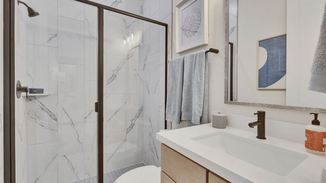 Discover refined elegance with marble tile shower and modern fixtures in Sunfield's luxurious bathroom. Discover refined elegance with marble tile shower and modern fixtures in Sunfield's luxurious bathroom.