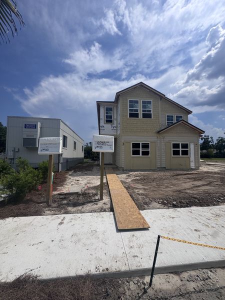 A new two-story home under construction in Baxley Villas by Drees Custom Homes, Middleburg, FL, with a clear blue sky backdrop. A new two-story home under construction in Baxley Villas by Drees Custom Homes, Middleburg, FL, with a clear blue sky backdrop.