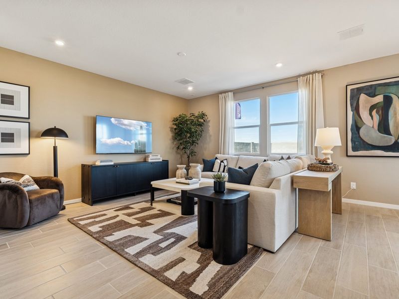 A living room with a large television.