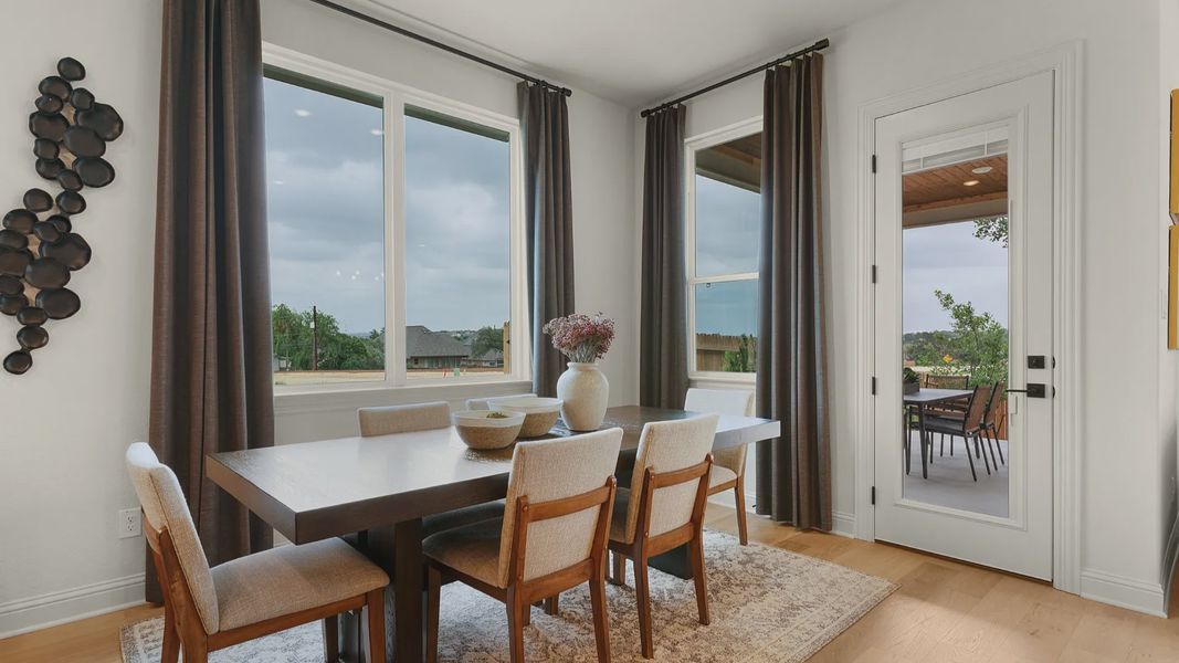 Casual dining area overlooking the covered patio with abundant natural light.