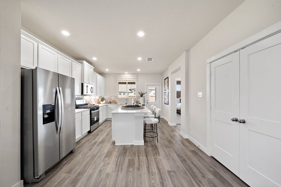 A kitchen with white cabinets.