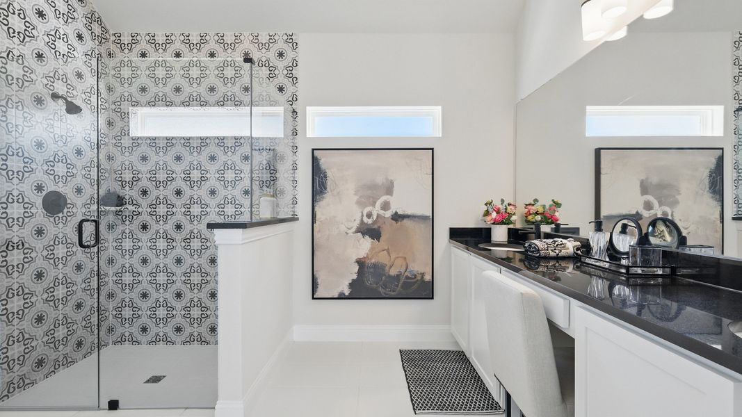 Experience sophistication with patterned tile shower and sleek counters in Green Oaks Preserve's exquisite bathroom. Experience sophistication with patterned tile shower and sleek counters in Green Oaks Preserve's exquisite bathroom.