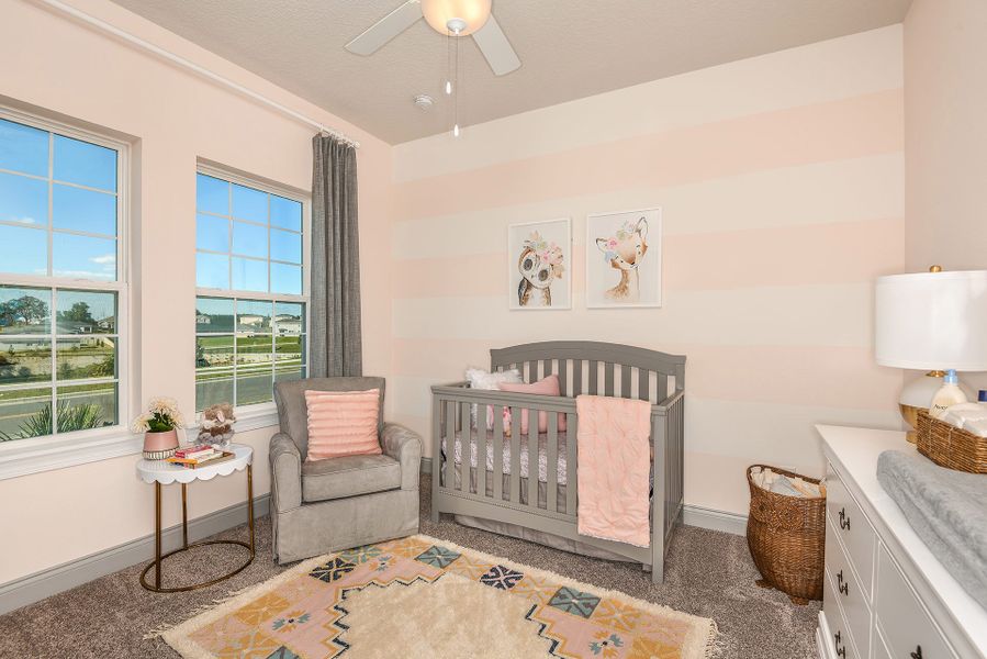 Furnished interior in a model home at John's Lake Landing - Cottage Series in Clermont (Image 11).