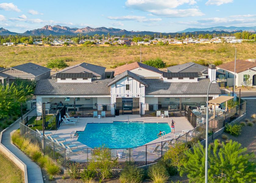 A large building with a pool in front of it. A large building with a pool in front of it.