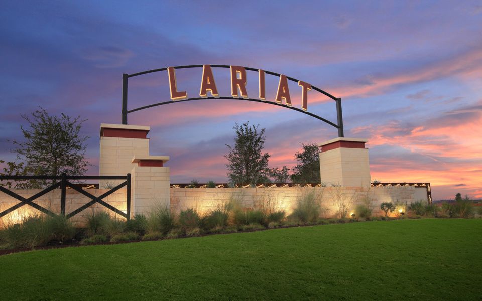 Entrance to the Lariat community in Liberty Hill, TX, featuring signage and landscaping (Image 4).