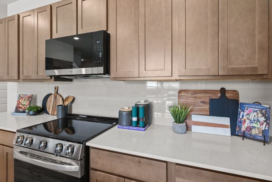 A kitchen with wooden cabinets.