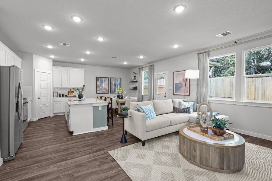 A living room with a white couch and a white table. A living room with a white couch and a white table.
