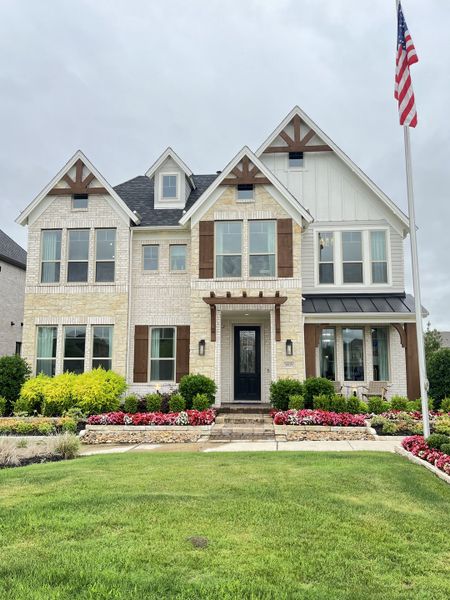 Charming white brick home with landscaped yard in Edgewater by Grand Homes (Fate, TX).