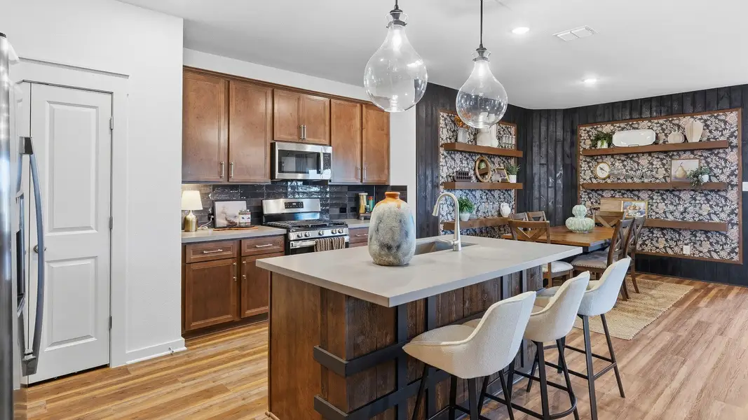 Experience elegance with this Infinity Square home featuring exquisite brickwork and a gabled roof.