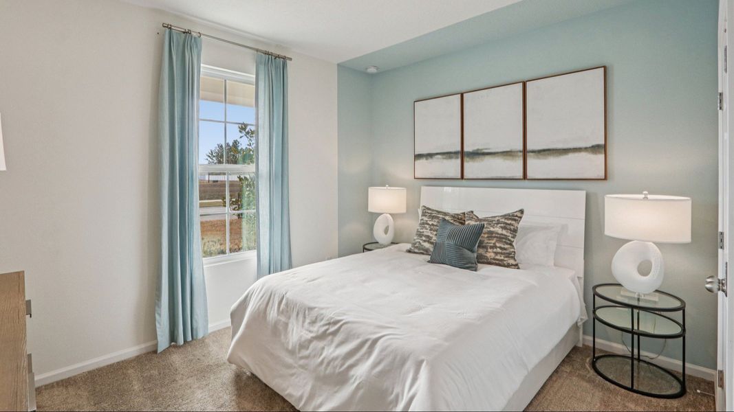 Luxurious bedroom features serene blue walls and plush carpet, offering tranquil elegance in Panther Creek. Luxurious bedroom features serene blue walls and plush carpet, offering tranquil elegance in Panther Creek.