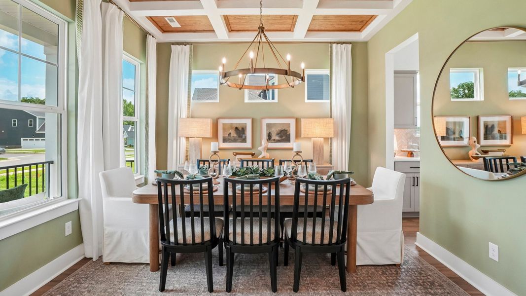 Dedicated dining room with coffered ceiling and access to kitchen