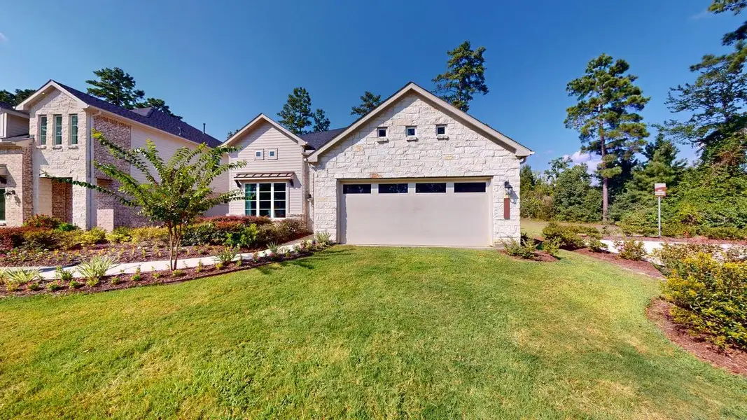 Front exterior of a home in the Audubon 50's community, located in Magnolia, TX (Image 2). Front exterior of a home in the Audubon 50's community, located in Magnolia, TX (Image 2).