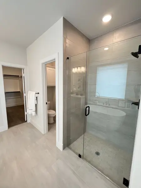 A sleek bathroom with a glass shower, beige tiles, and modern fixtures, offering both style and functionality. A sleek bathroom with a glass shower, beige tiles, and modern fixtures, offering both style and functionality.