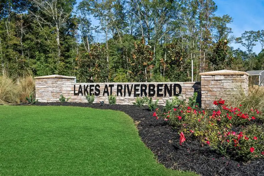 Entrance to the Lakes at Riverbend Single Family Homes community in Navassa, NC, featuring signage and landscaping (Image 2).
