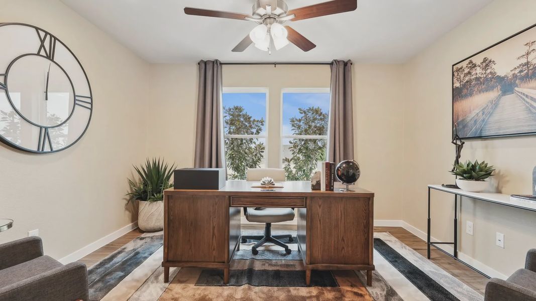 Bask in the elegance of a refined home office with rich wood tones and natural light in Simpson Crossing.