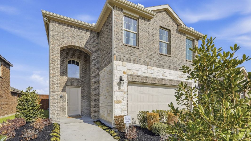 Front exterior of a home in the The Woods at Lindsey Place community, located in Anna, TX (Image 17).