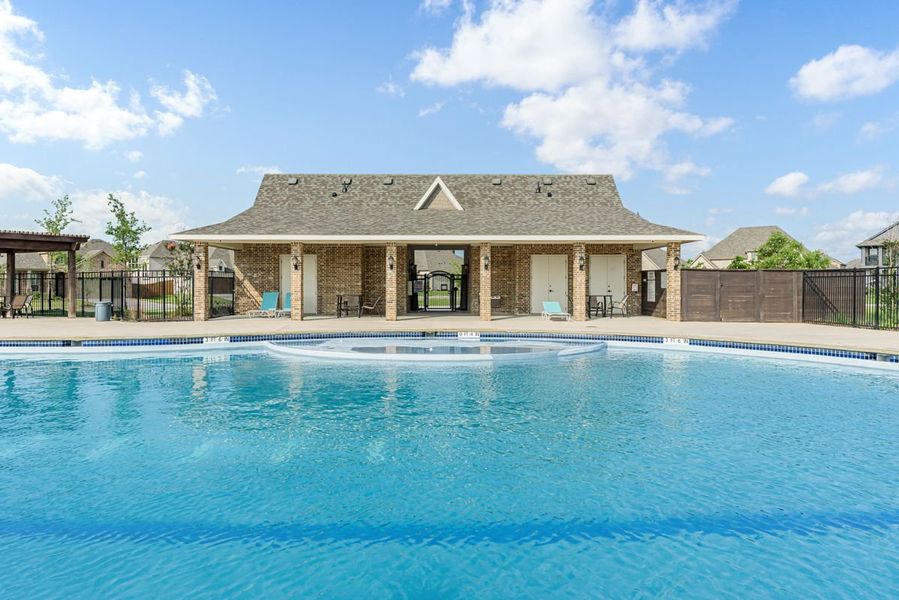 Community pool with brick clubhouse, covered patio, lounge chairs, and iron fence surrounding the area Community pool with brick clubhouse, covered patio, lounge chairs, and iron fence surrounding the area