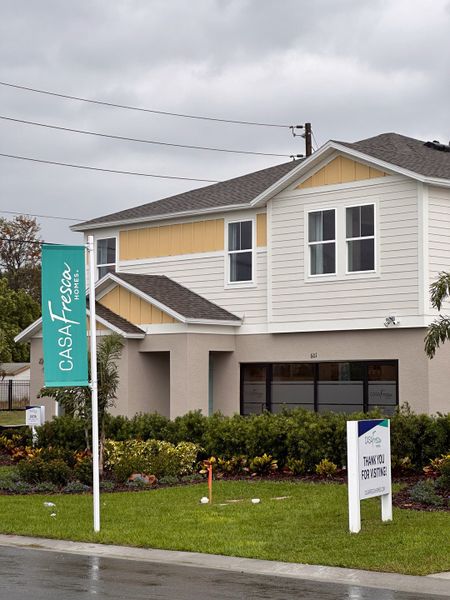 A charming two-story home with a landscaped yard in Bradbury Creek by Casa Fresca Homes (Haines City, FL).