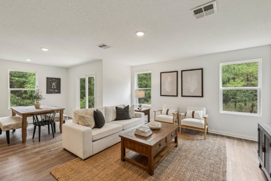 A living room with a white couch and a table. A living room with a white couch and a table.