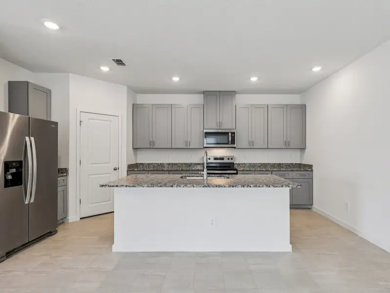 Furnished interior in a model home at Lakes at Bella Lago - Premier Series in Green Cove Springs (Image 4).